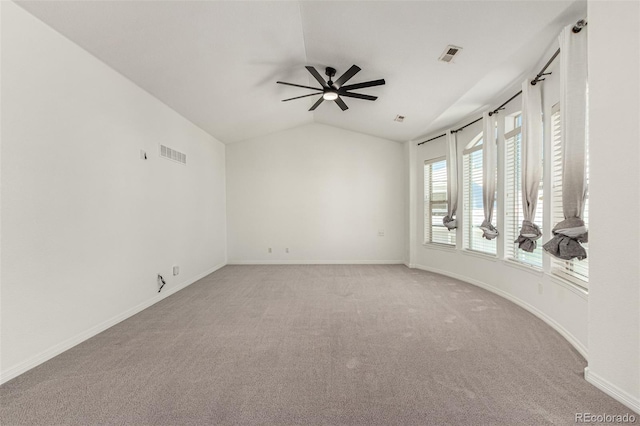 spare room featuring carpet, ceiling fan, and lofted ceiling