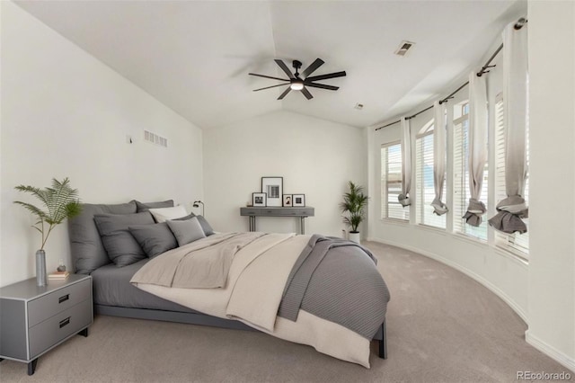 bedroom featuring ceiling fan, light colored carpet, and vaulted ceiling