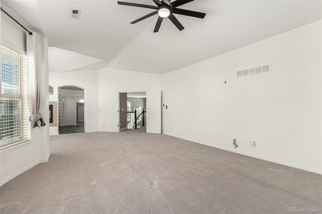 carpeted spare room with vaulted ceiling and ceiling fan