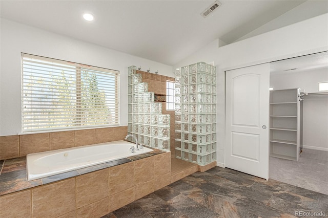 bathroom featuring separate shower and tub and vaulted ceiling