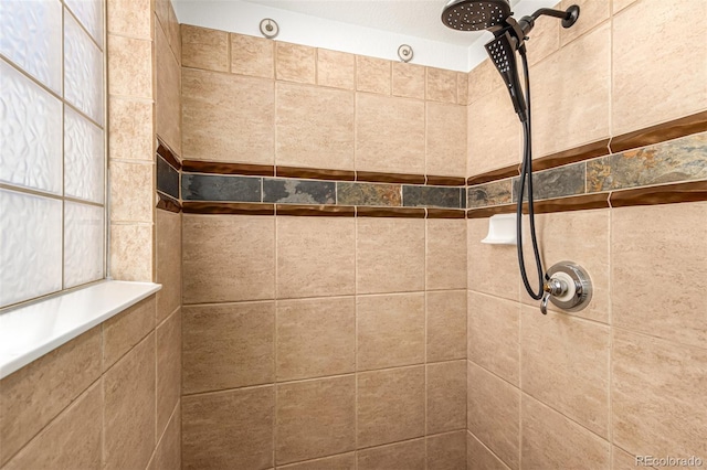 bathroom with tiled shower