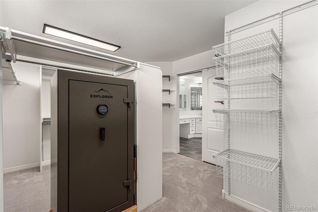 spacious closet featuring light carpet