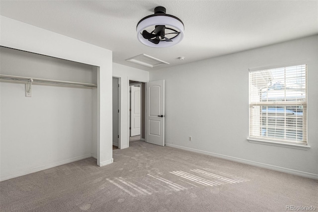 unfurnished bedroom featuring light colored carpet and a closet