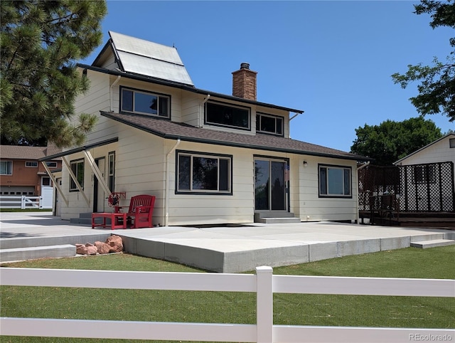 8414 S Otis St, Littleton, CO 80128 - rear view of property with a chimney, a patio, and entry steps