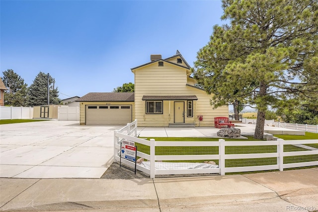 8414 S Otis St, Littleton, CO 80128 - view of front of house with driveway, an attached garage, a fenced front yard, and a chimney