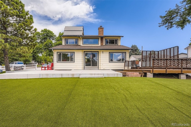 8414 S Otis St, Littleton, CO 80128 - rear view of house featuring a chimney, a yard, and a wooden deck