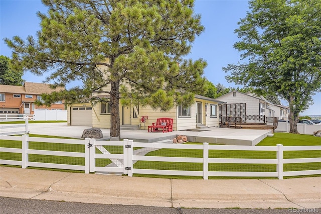 8414 S Otis St, Littleton, CO 80128 - view of front of home featuring concrete driveway, a fenced front yard, a garage, and a gate