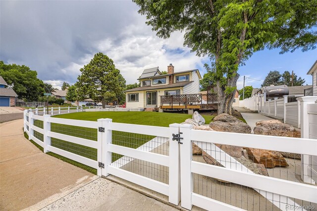 8414 S Otis St, Littleton, CO 80128 - view of front facade featuring a gate, a fenced front yard, and a deck