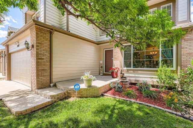 5133 E Essex Ave, Castle Rock, CO 80104 - entrance to property with brick siding, a garage, and a lawn