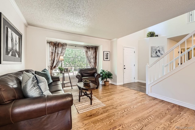 5133 E Essex Ave, Castle Rock, CO 80104 - living room featuring a textured ceiling, wood finished floors, stairway, and crown molding
