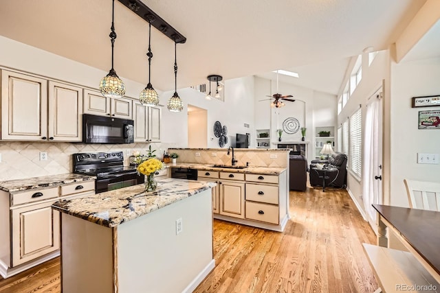 5133 E Essex Ave, Castle Rock, CO 80104 - kitchen with black appliances, ceiling fan, a peninsula, cream cabinets, and open floor plan