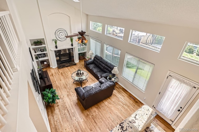 5133 E Essex Ave, Castle Rock, CO 80104 - living room with a towering ceiling, plenty of natural light, wood finished floors, and a ceiling fan