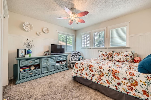 5133 E Essex Ave, Castle Rock, CO 80104 - carpeted bedroom featuring wainscoting, a textured ceiling, and a ceiling fan