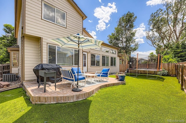 5133 E Essex Ave, Castle Rock, CO 80104 - back of house with a trampoline, a patio area, and a fenced backyard