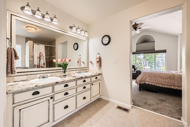 5133 E Essex Ave, Castle Rock, CO 80104 - ensuite bathroom with double vanity, tile patterned floors, a ceiling fan, lofted ceiling, and a shower with curtain