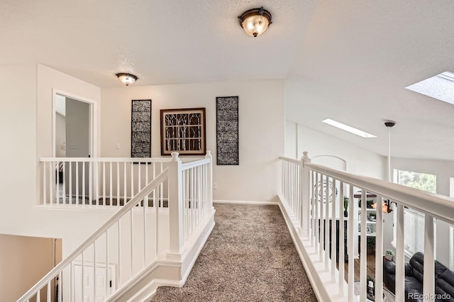 5133 E Essex Ave, Castle Rock, CO 80104 - hall featuring a skylight, an upstairs landing, carpet, and a textured ceiling