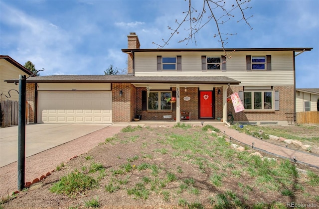3006 Oro Blanco Dr, Colorado Springs, CO 80917 - traditional home with a chimney, fence, driveway, a porch, and a garage