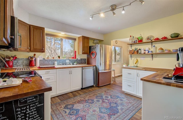 3006 Oro Blanco Dr, Colorado Springs, CO 80917 - kitchen featuring butcher block countertops, white cabinets, appliances with stainless steel finishes, and a sink