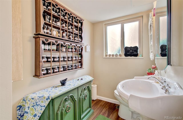 3006 Oro Blanco Dr, Colorado Springs, CO 80917 - bathroom with baseboards, wood finished floors, a sink, and toilet