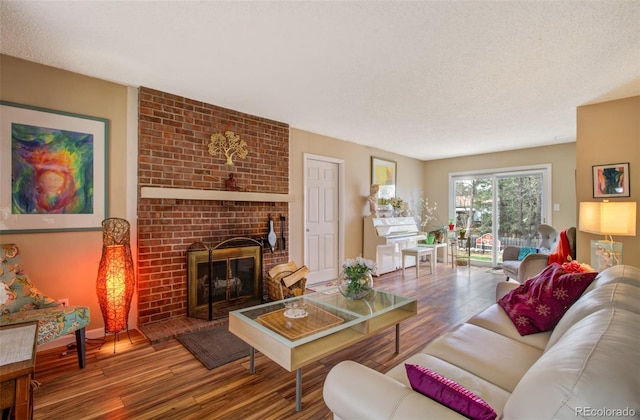 3006 Oro Blanco Dr, Colorado Springs, CO 80917 - living room with baseboards, a brick fireplace, wood finished floors, and a textured ceiling