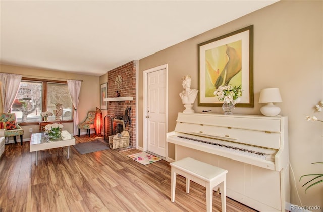 3006 Oro Blanco Dr, Colorado Springs, CO 80917 - sitting room with a brick fireplace and wood finished floors