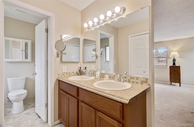 3006 Oro Blanco Dr, Colorado Springs, CO 80917 - full bathroom featuring toilet, a sink, double vanity, and baseboards