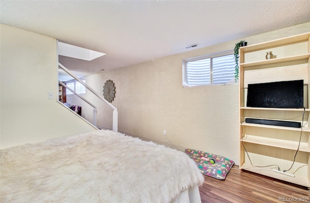3006 Oro Blanco Dr, Colorado Springs, CO 80917 - bedroom with wood finished floors, visible vents, and a skylight