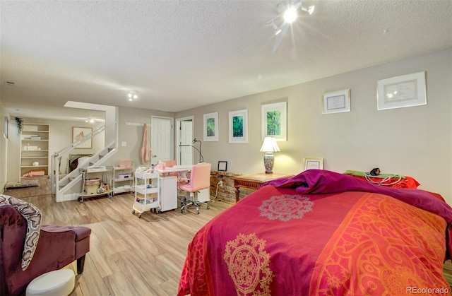 3006 Oro Blanco Dr, Colorado Springs, CO 80917 - bedroom featuring wood finished floors and a textured ceiling