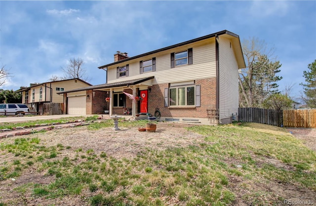 3006 Oro Blanco Dr, Colorado Springs, CO 80917 - traditional-style home with a chimney, concrete driveway, fence, brick siding, and a garage