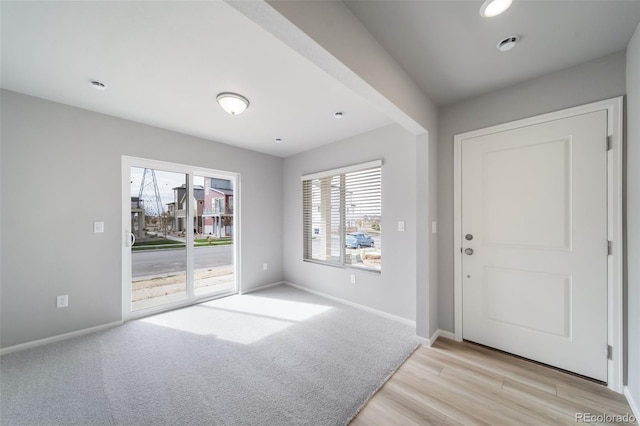 entrance foyer featuring baseboards and light wood-type flooring