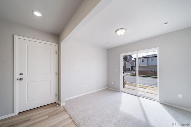 unfurnished room featuring baseboards and wood finished floors
