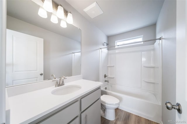 bathroom with toilet, vanity, wood finished floors, and bathing tub / shower combination