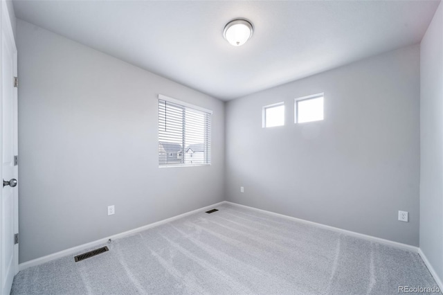carpeted empty room with baseboards