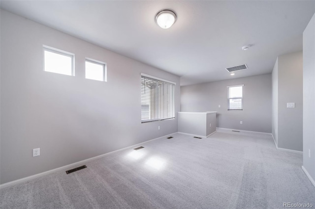 below grade area featuring baseboards and light carpet