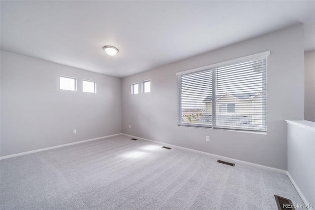 carpeted spare room with baseboards