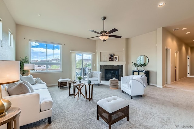 living room with carpet flooring, a ceiling fan, baseboards, and visible vents