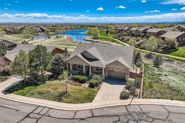 birds eye view of property featuring a water view and a residential view