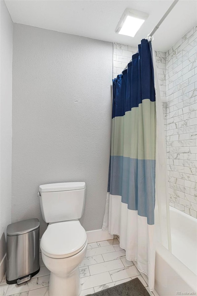 7373 E Iowa Ave Unit 1101, Denver, CO 80231 - bathroom featuring marble look tiles, toilet, shower / tub combo with curtain, and baseboards
