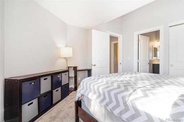 bedroom featuring connected bathroom and carpet floors