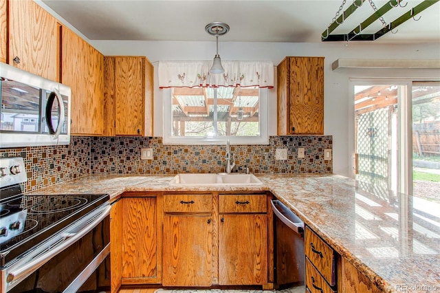 kitchen featuring stainless steel appliances, a sink, light countertops, and backsplash
