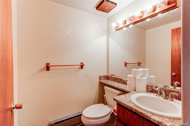 half bathroom featuring toilet, a baseboard radiator, and vanity