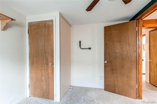 unfurnished bedroom featuring carpet floors and a ceiling fan