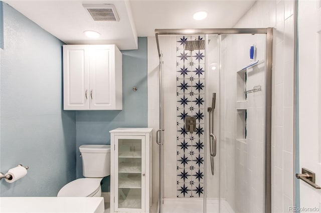 full bathroom with toilet and a shower stall