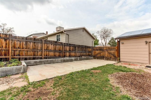fenced backyard featuring a patio area and a gate