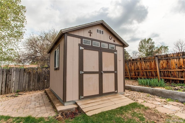 view of shed with a fenced backyard
