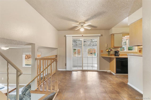 kitchen featuring light tile patterned floors, a textured ceiling, black dishwasher, and ceiling fan