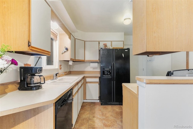 kitchen featuring light tile patterned floors, white cabinetry, sink, and black appliances