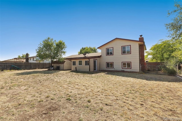 rear view of property with a lawn