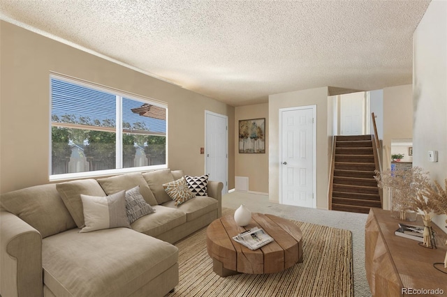 carpeted living room with a textured ceiling