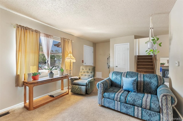 living room with carpet flooring and a textured ceiling